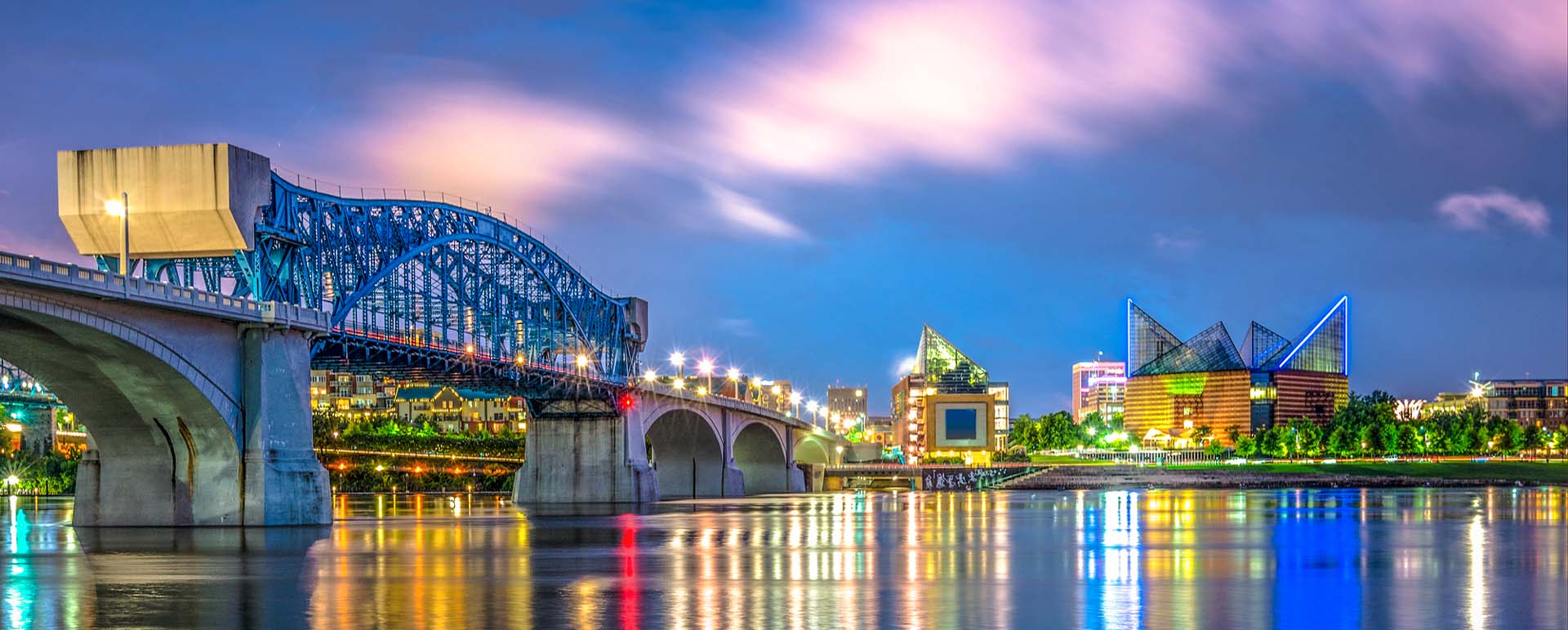 Neon color image of a band playing and people singing along