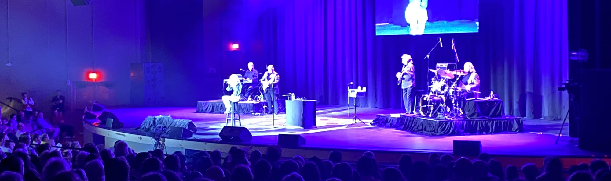 signer on stage in chair washed out by the lights Chattanooga